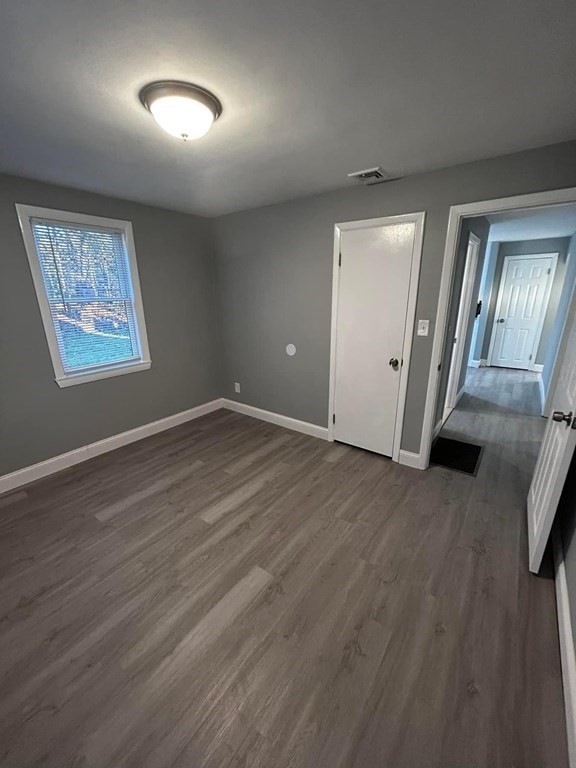 89 Gatewood Road Springfield, MA 01119 - Photo 20 of 30 an empty room with wooden floor and windows