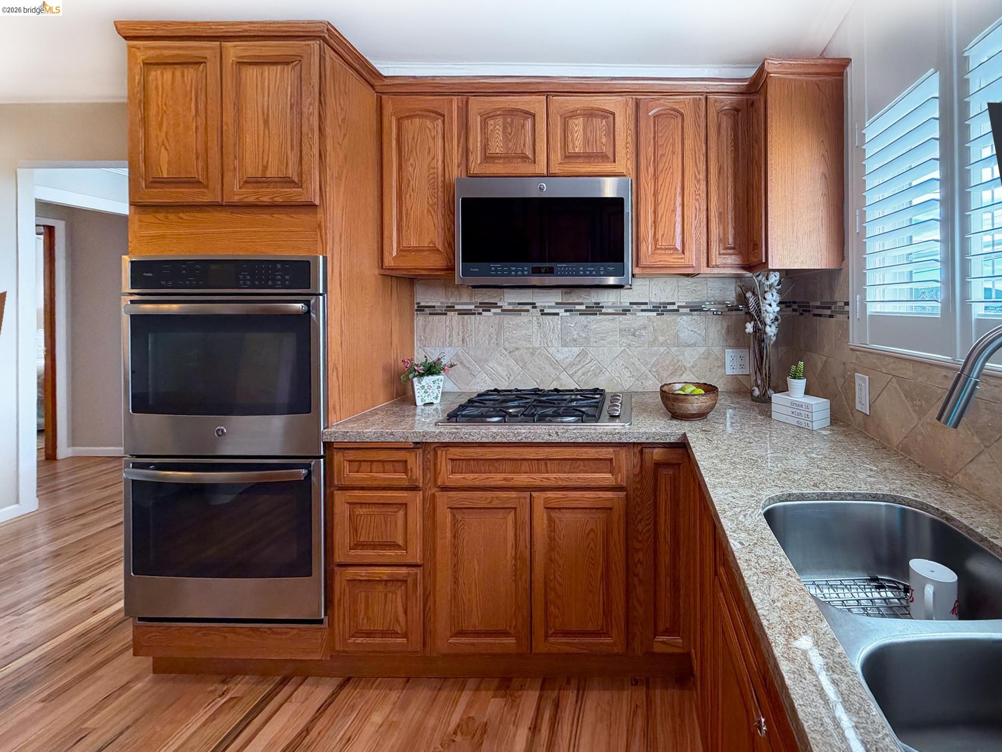 1732 Fernando Street Seaside, CA 93955 - Photo 17 of 53 Kitchen featuring stainless steel appliances, wood finish cabinets, and light stone countertops