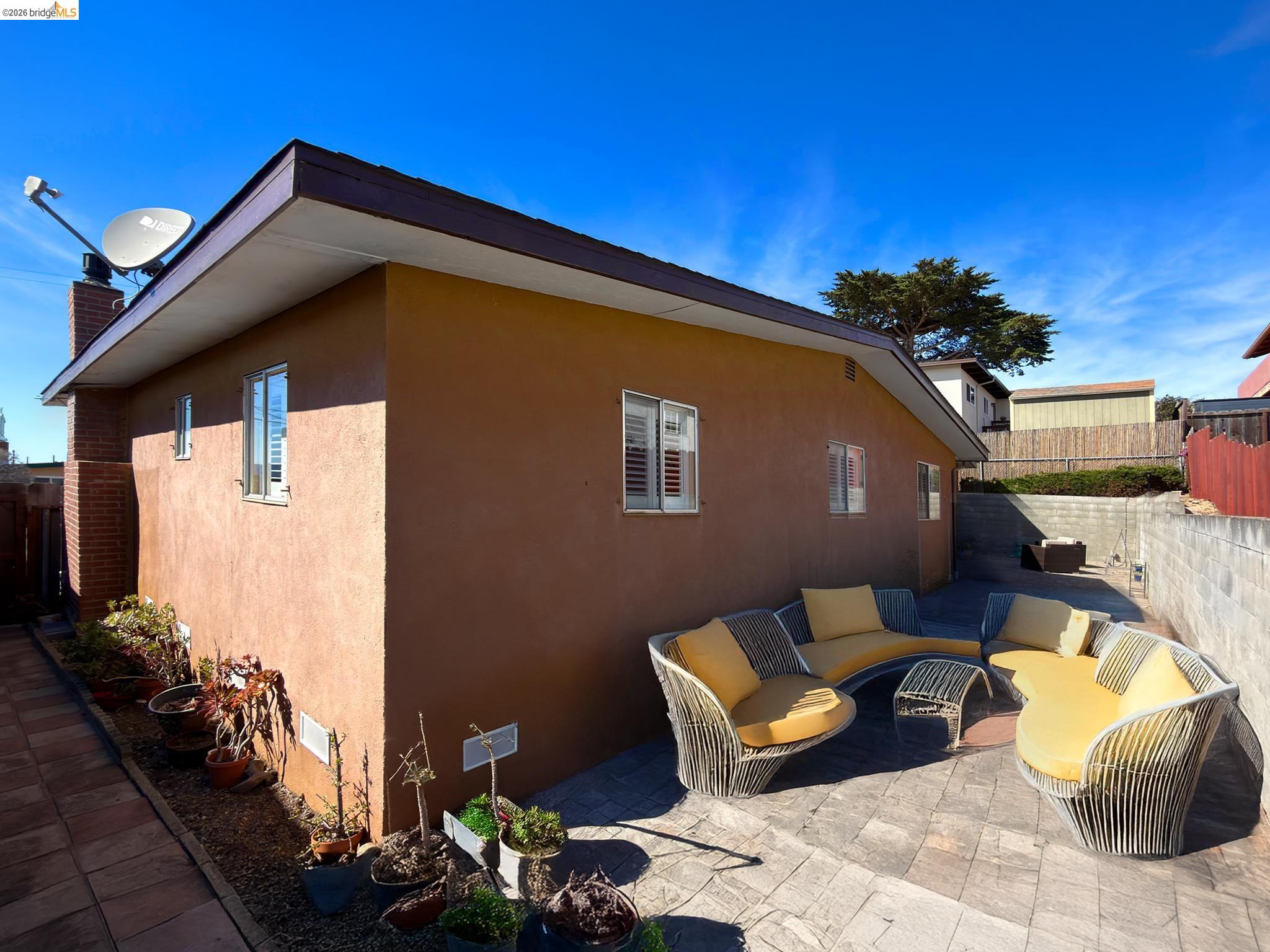 1732 Fernando Street Seaside, CA 93955 - Photo 53 of 53 View of side of home featuring an outdoor lounge area, stucco siding, a patio, and a chimney