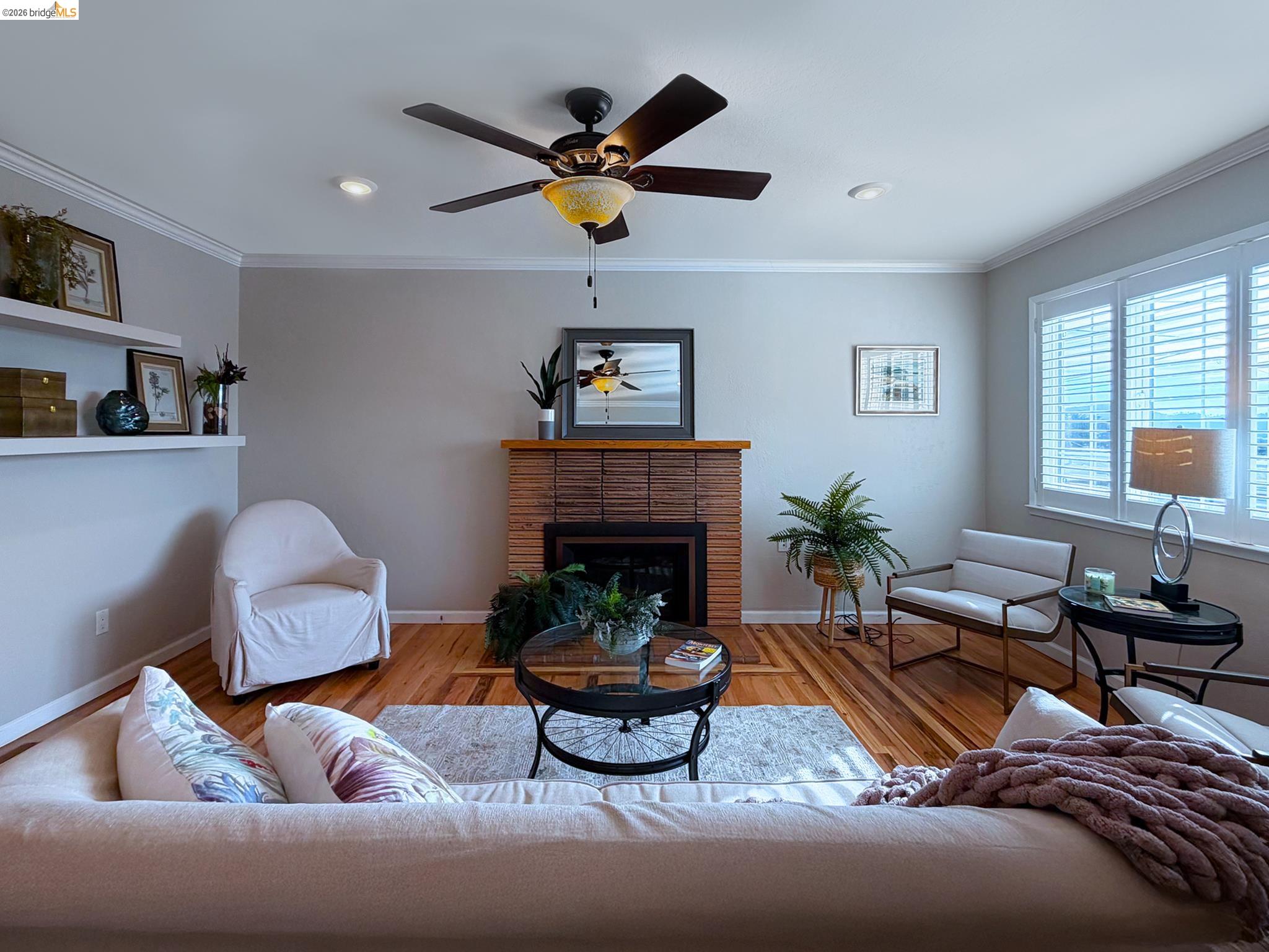 1732 Fernando Street Seaside, CA 93955 - Photo 10 of 53 Living area featuring a brick fireplace, light wood finished floors, ornamental molding, and a ceiling fan