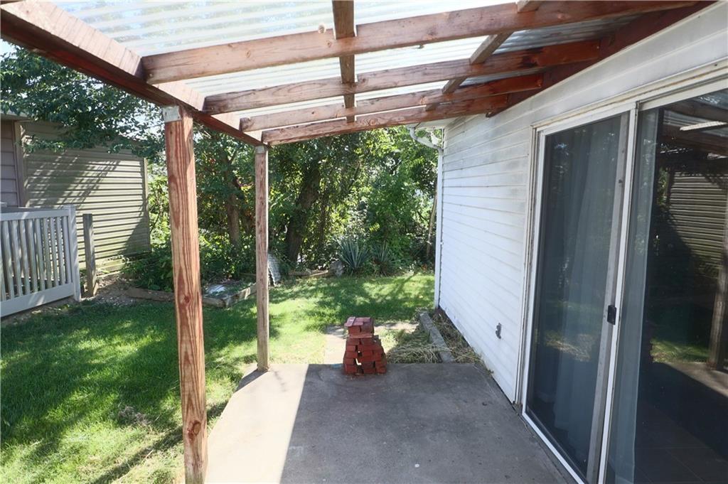 1340 Barkley Road McKeesport, PA 15133 - Photo 17 of 20 a view of a porch with a floor to ceiling window and garden