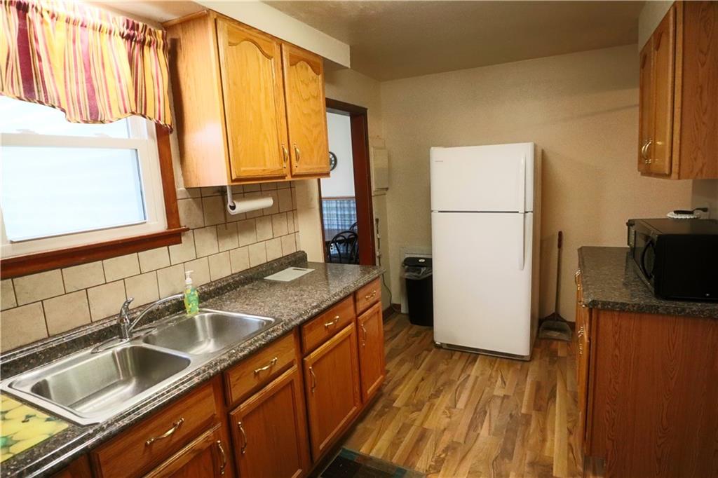1340 Barkley Road McKeesport, PA 15133 - Photo 4 of 20 a kitchen with sink a refrigerator and a stove