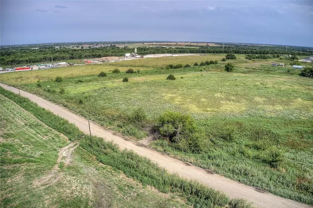 a view of a field with an ocean view