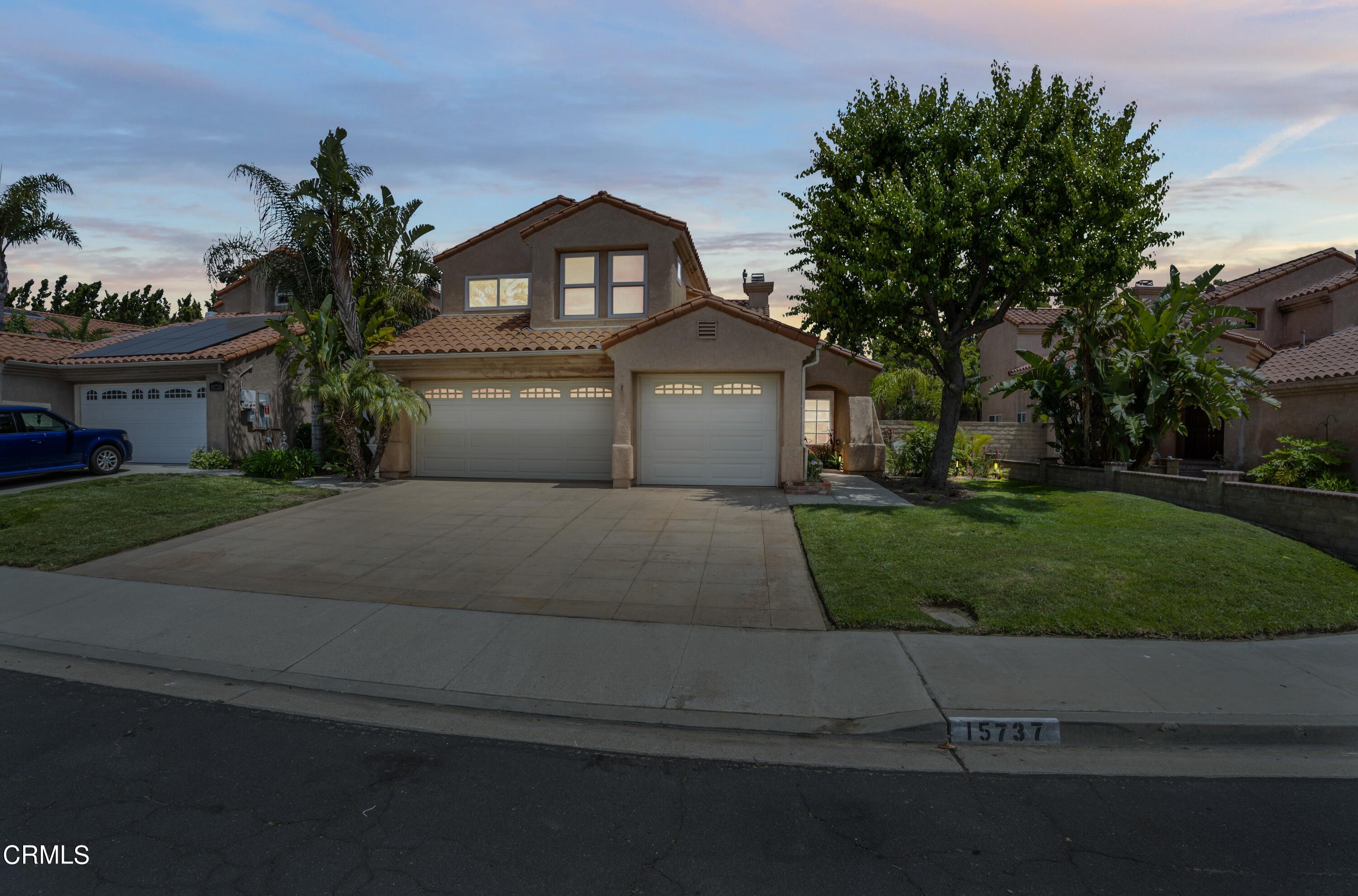a front view of a house with a garden and yard