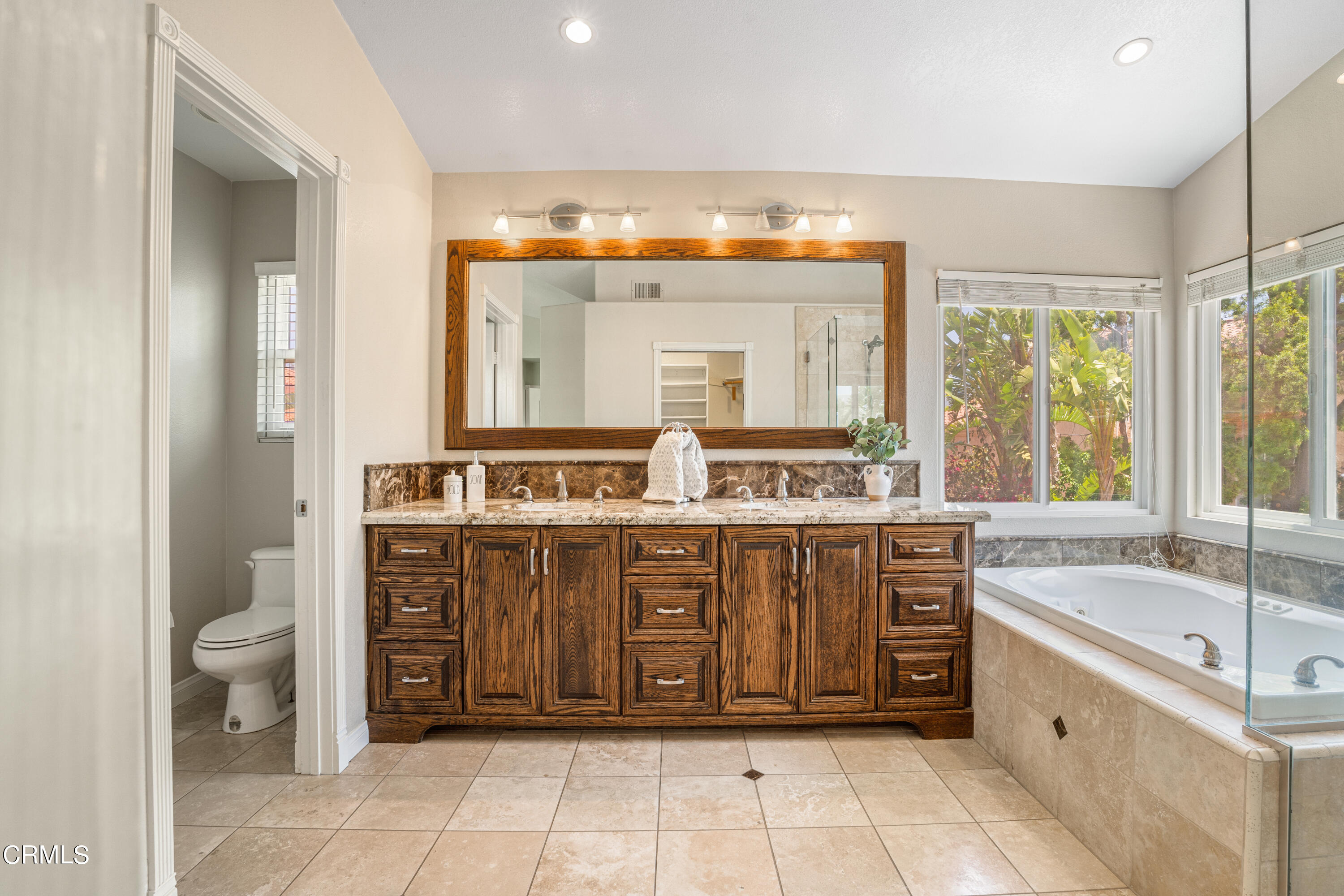 15737 Milne Circle Moorpark, CA 93021 - Photo 19 of 38 a spacious bathroom with a granite countertop tub sink and a mirror