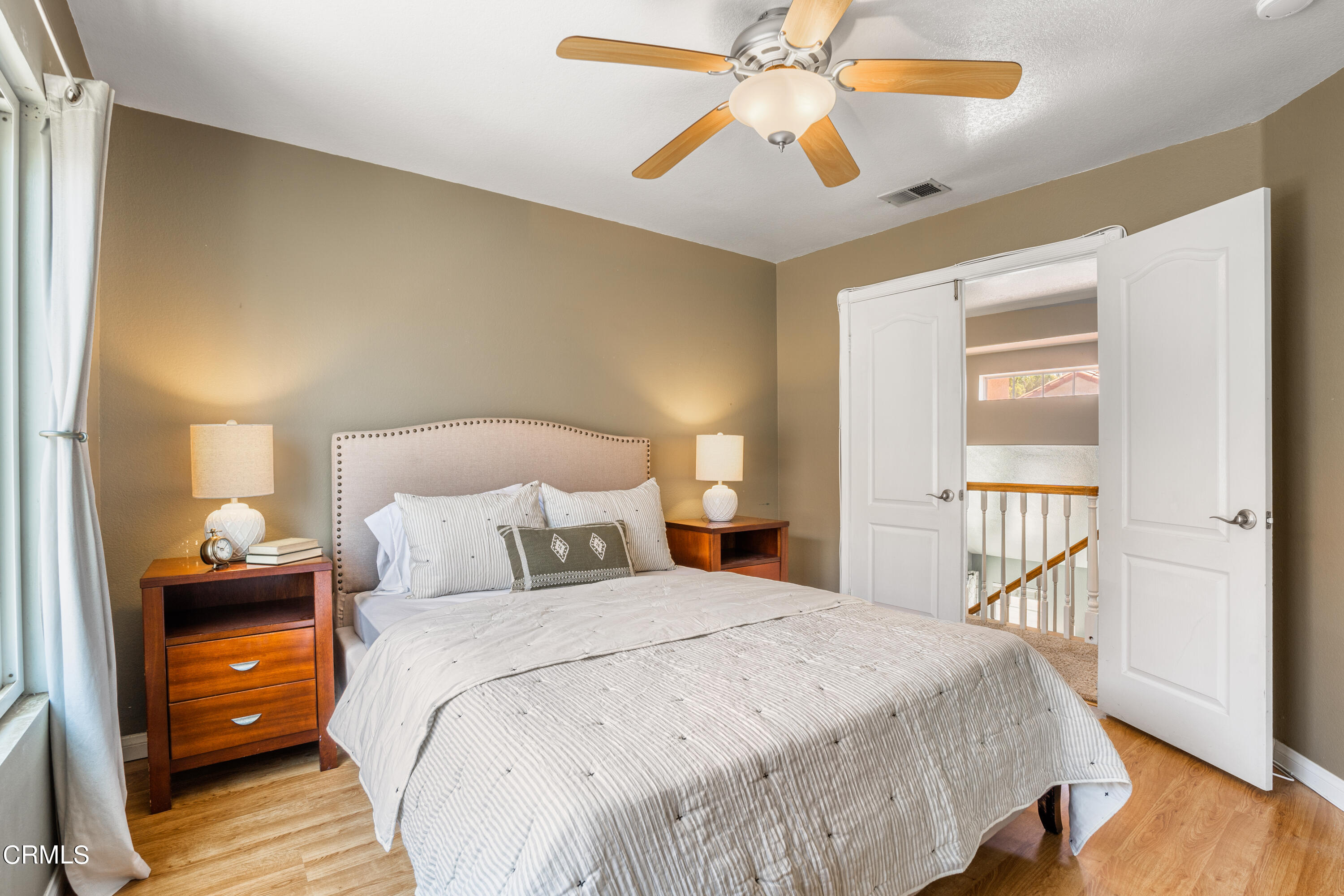 15737 Milne Circle Moorpark, CA 93021 - Photo 23 of 38 a bedroom with a bed and wooden floor