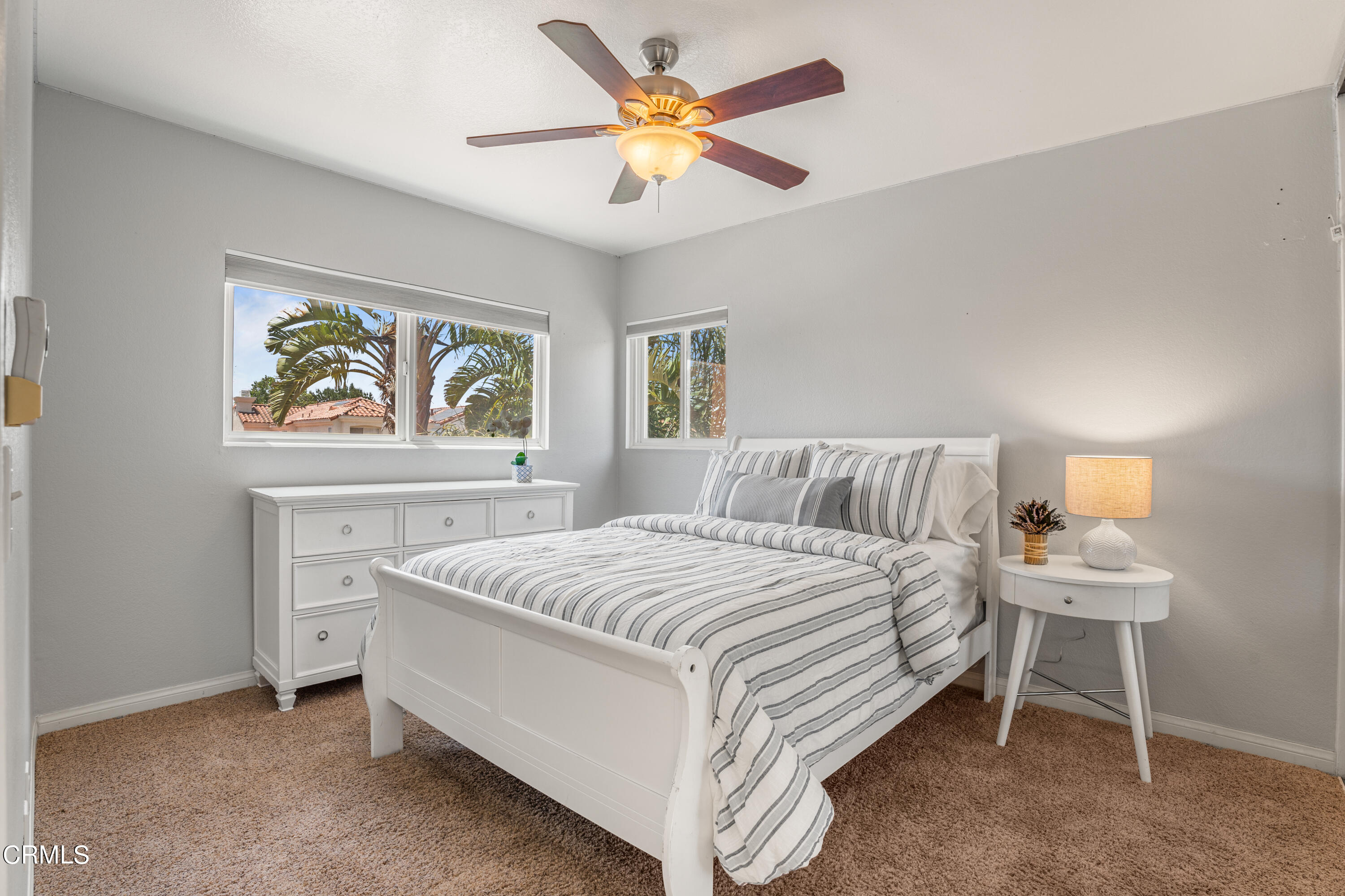 15737 Milne Circle Moorpark, CA 93021 - Photo 26 of 38 a bedroom with a bed and a chandelier