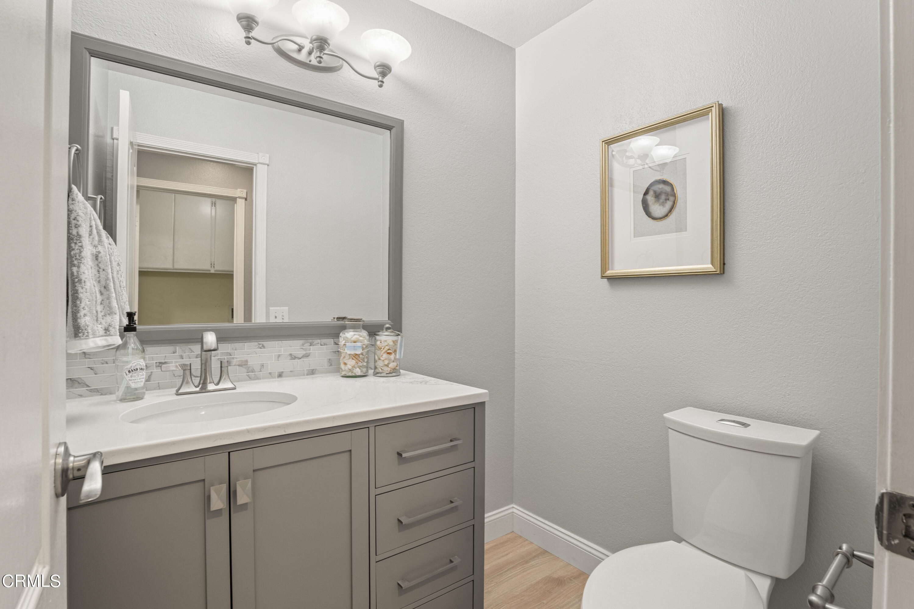 15737 Milne Circle Moorpark, CA 93021 - Photo 30 of 38 a bathroom with a toilet a sink and mirror