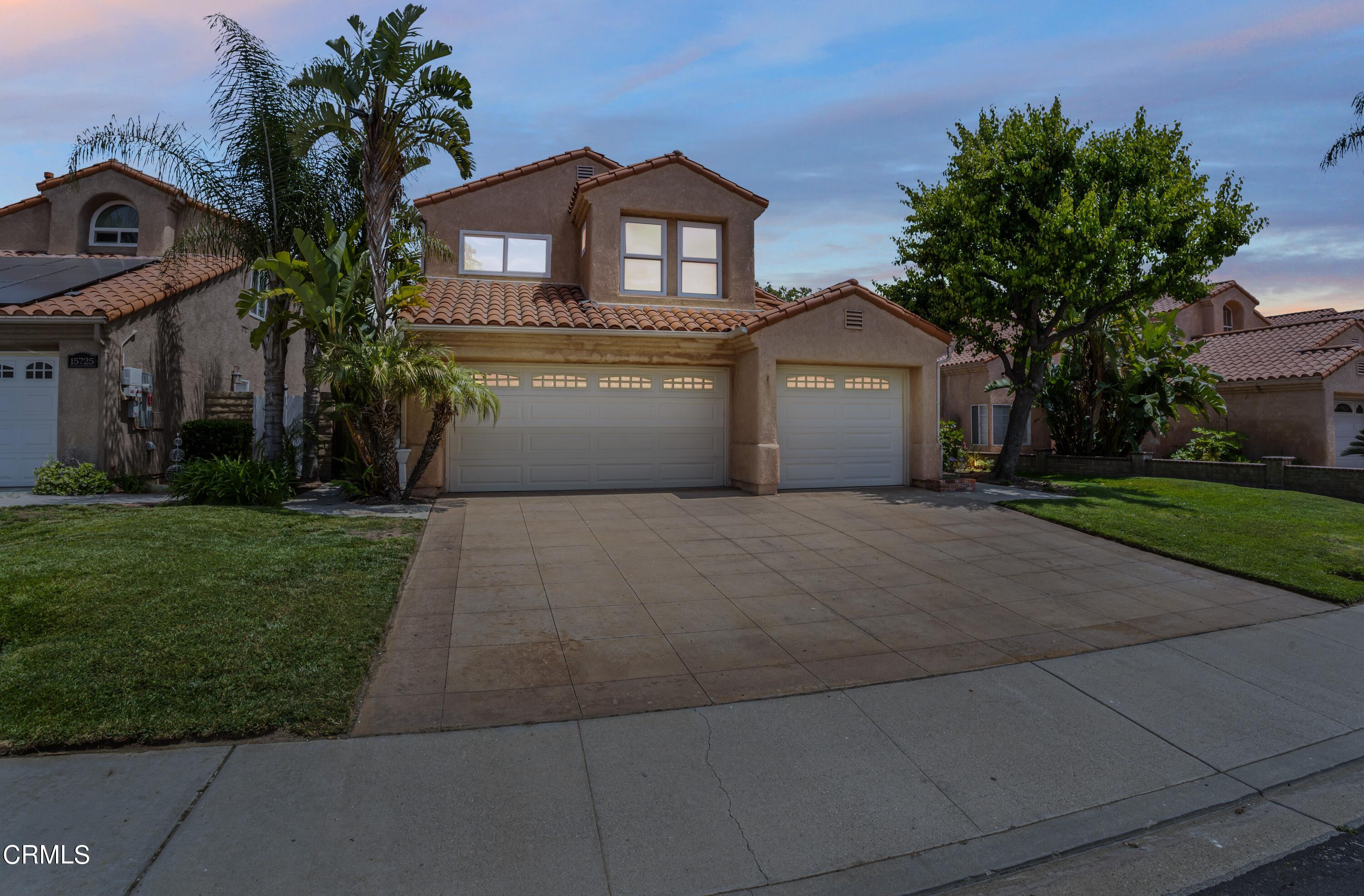 15737 Milne Circle Moorpark, CA 93021 - Photo 38 of 38 a front view of a house with a garden and trees