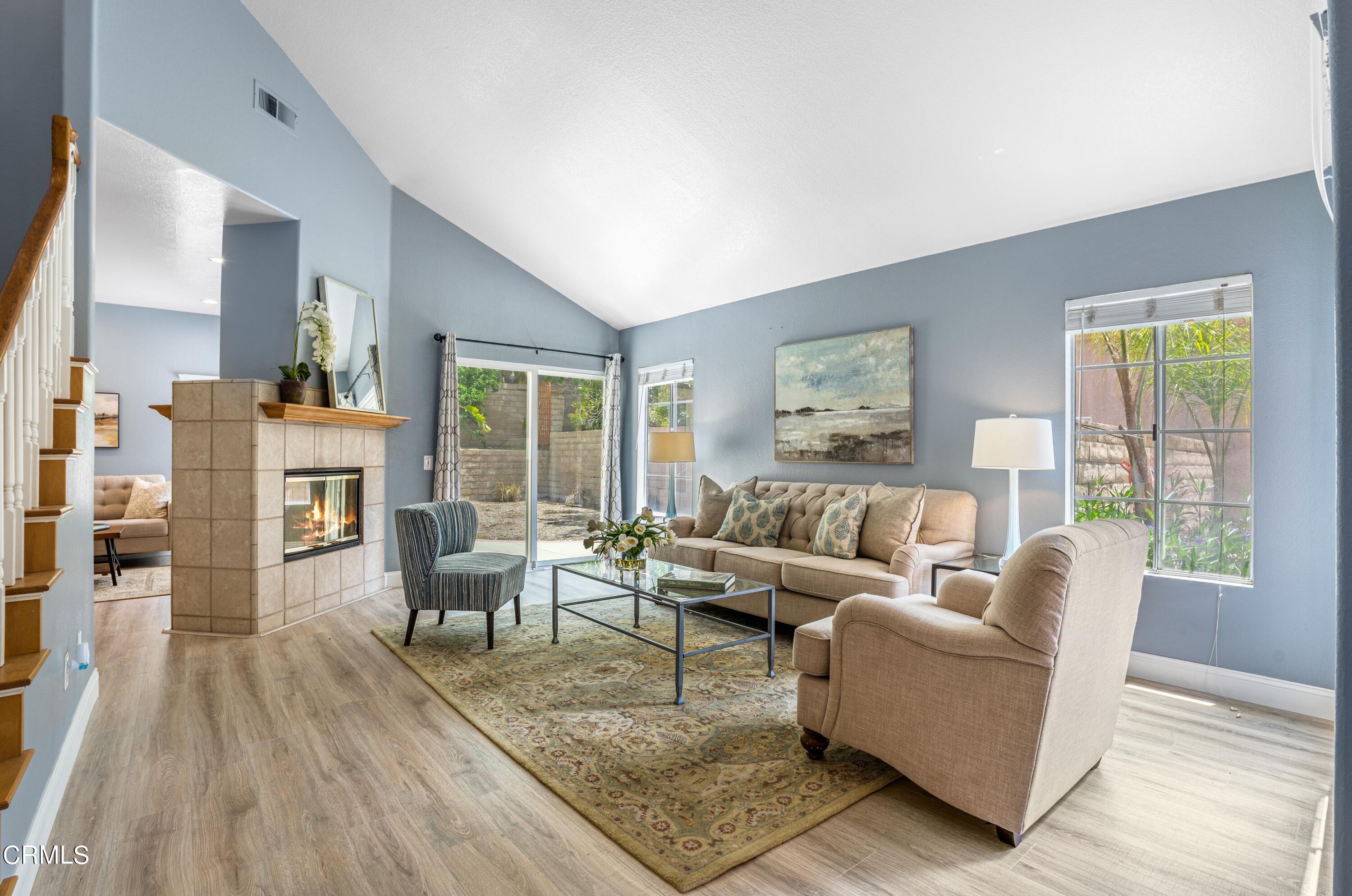15737 Milne Circle Moorpark, CA 93021 - Photo 6 of 38 a living room with fireplace furniture wooden floor and a large window