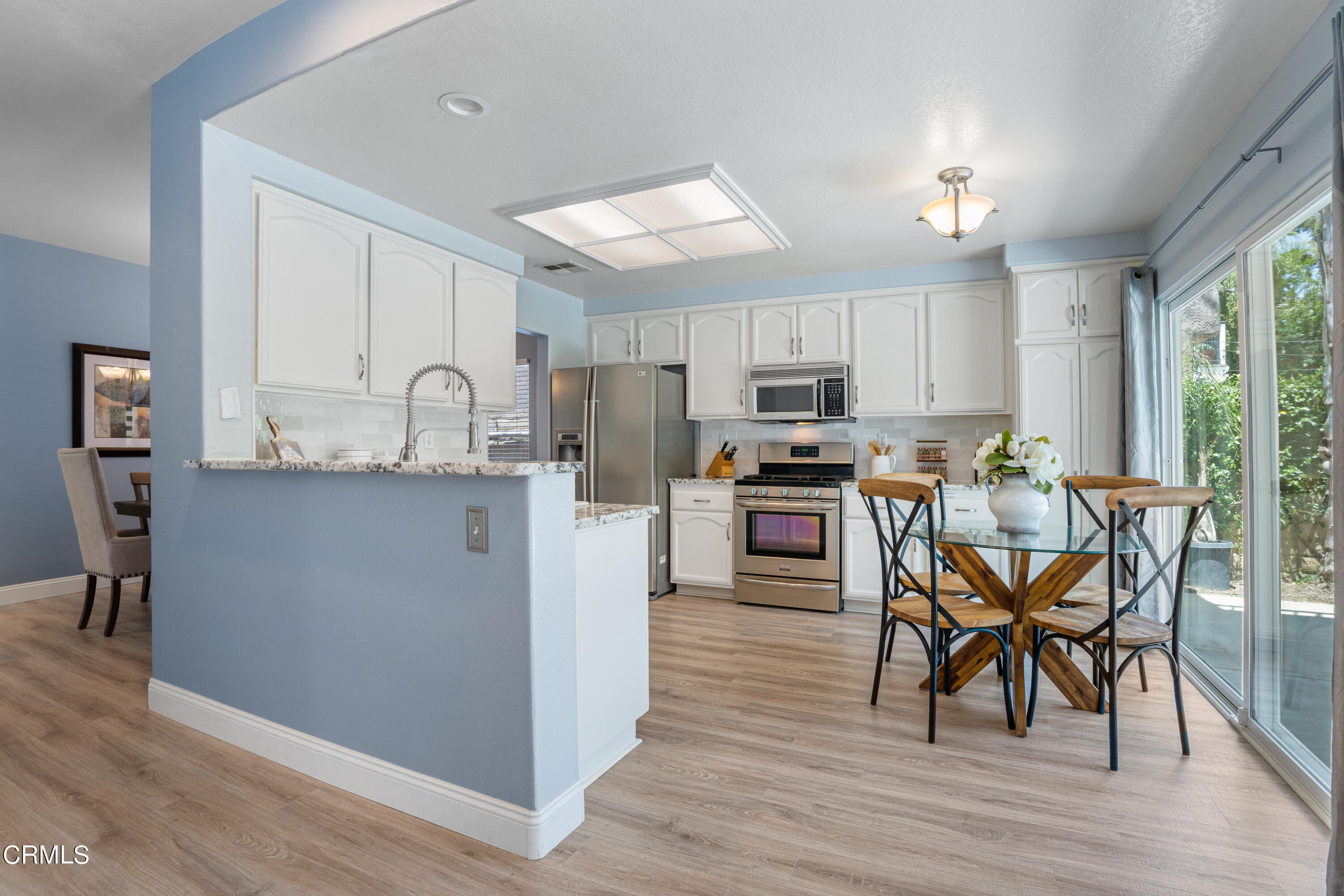 15737 Milne Circle Moorpark, CA 93021 - Photo 10 of 38 a kitchen with stainless steel appliances granite countertop a table chairs microwave and sink