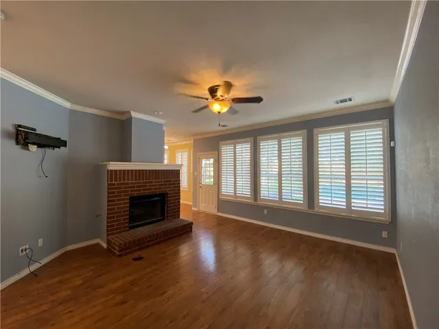 wooden floor fireplace and natural light in room