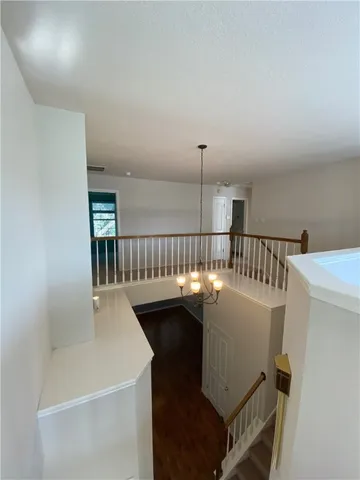 a dining room with furniture and a floor to ceiling window