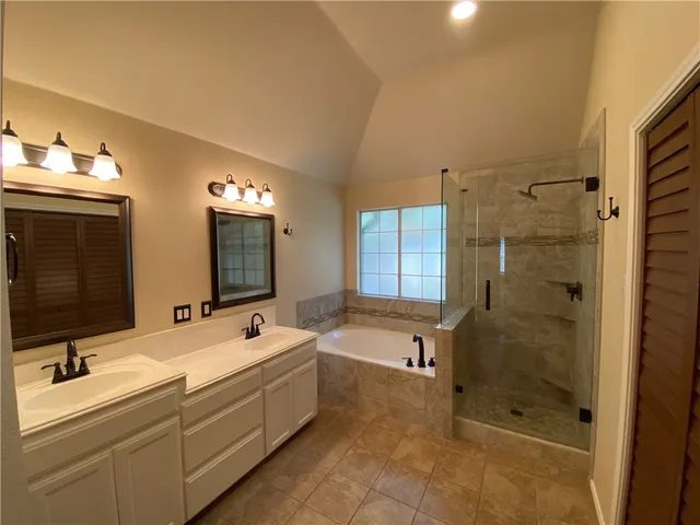 a bathroom with a double vanity sink toilet mirror and shower