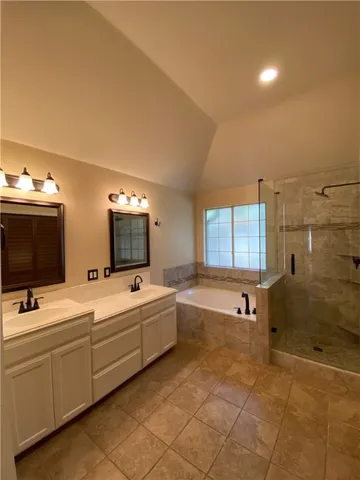 a bathroom with 2 sink tub and shower