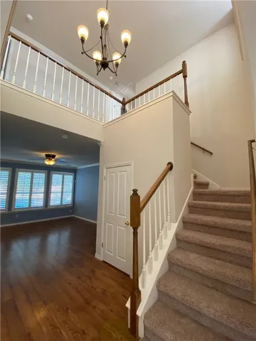 a view of staircase with lots of frames and a window