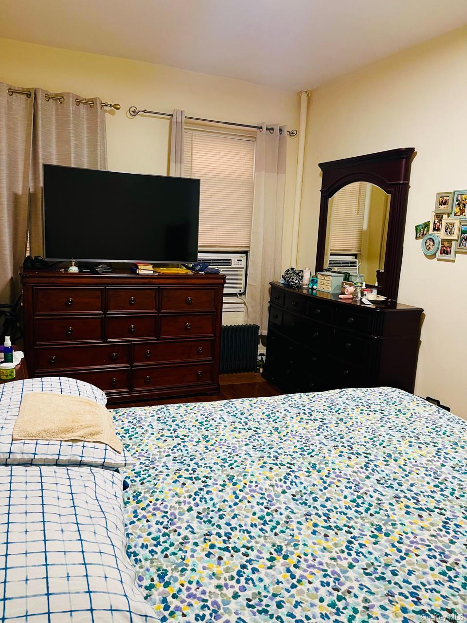 37-21 80th Street, Unit 1D Queens, NY 11372 - Photo 3 of 10 a living room with a couch and a flat screen tv