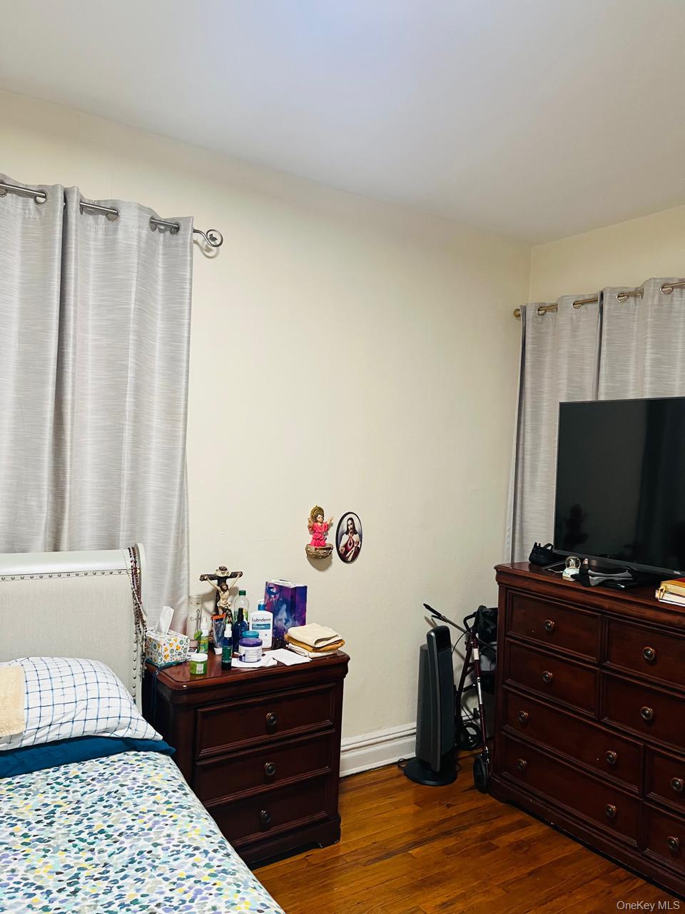 37-21 80th Street, Unit 1D Queens, NY 11372 - Photo 4 of 10 a living room with furniture and a flat screen tv