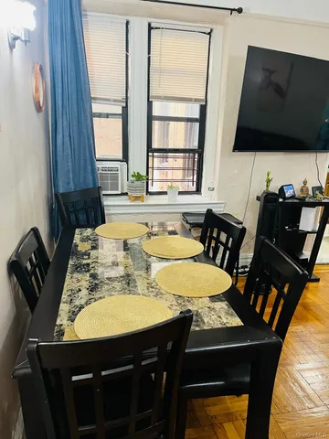 a dining room with furniture and window
