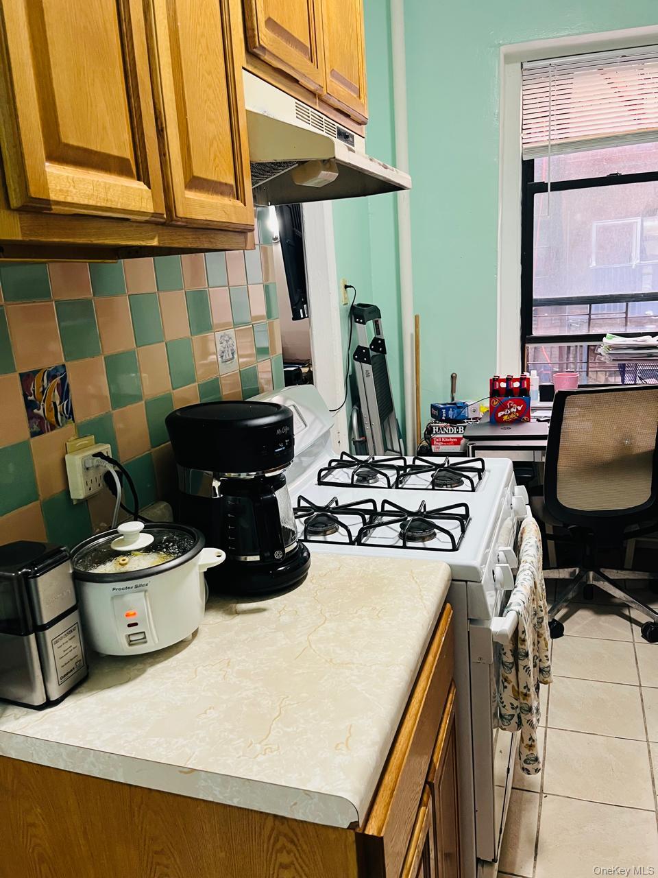 37-21 80th Street, Unit 1D Queens, NY 11372 - Photo 8 of 10 a work place with table and chairs