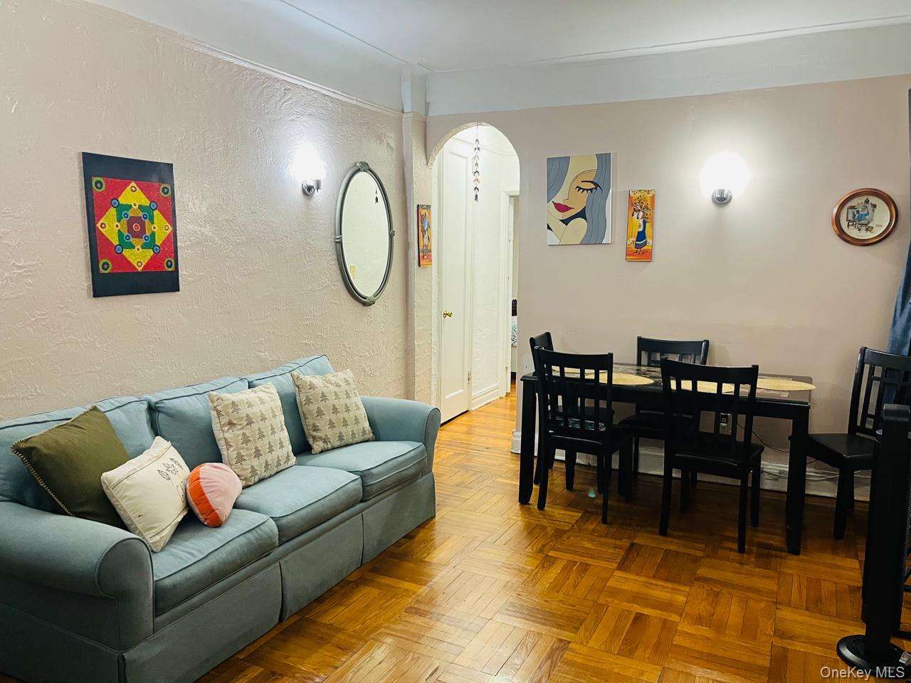 37-21 80th Street, Unit 1D Queens, NY 11372 - Photo 9 of 10 a living room with furniture a rug and a dining table