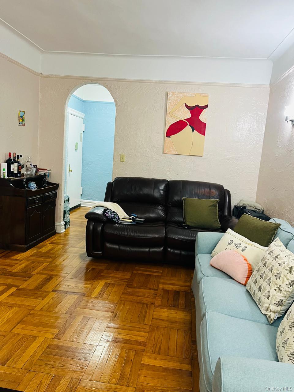 37-21 80th Street, Unit 1D Queens, NY 11372 - Photo 10 of 10 a living room with furniture and a flat screen tv