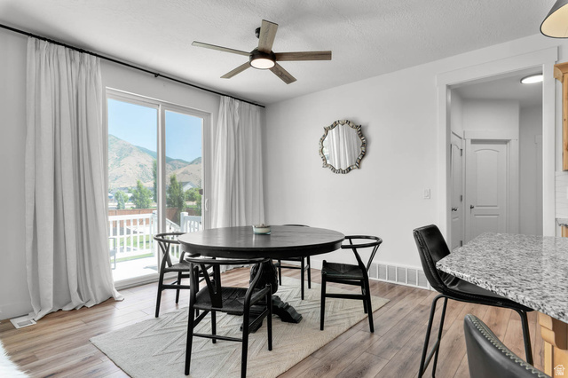500 North 516th Street West, Unit 19 Mapleton, UT 84664 - Photo 20 of 41 Dining area featuring wood-finish flooring, a contemporary ceiling fan, and a sliding glass door opening to an outdoor deck