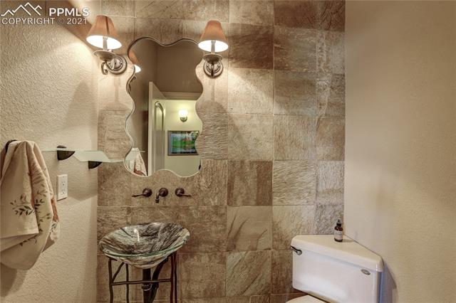 20 Keithley Road Manitou Springs, CO 80829 - Photo 36 of 42 Main level powder room with custom tile wall and hand-washing sink.