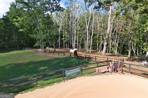 a view of a house with swimming pool and a yard