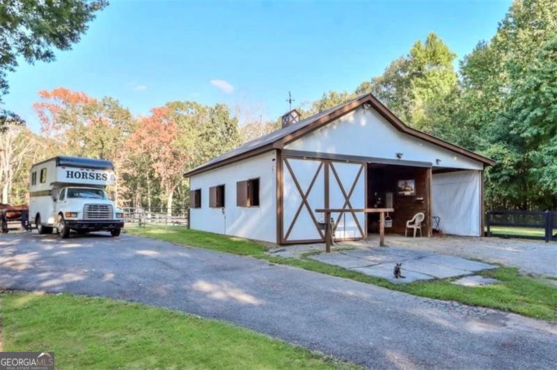 2203 Arbor Hill Road Canton, GA 30115 - Photo 22 of 64 a view of a house with a yard and chairs