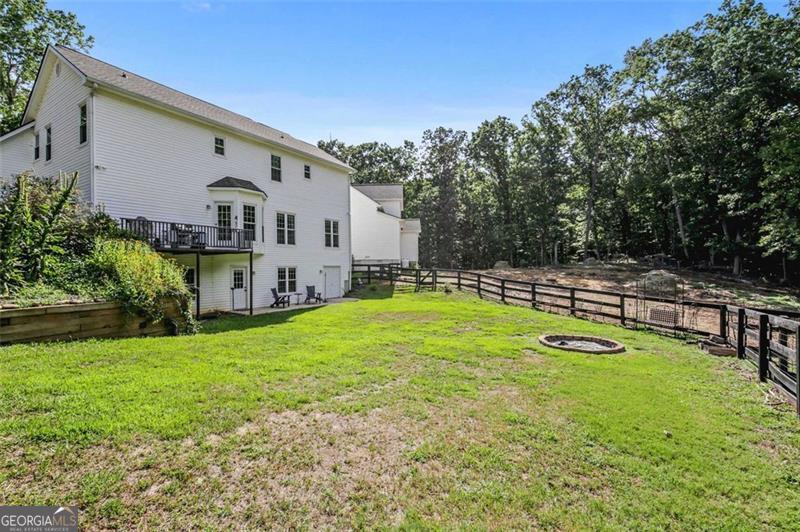 2203 Arbor Hill Road Canton, GA 30115 - Photo 28 of 64 a view of a house with swimming pool and a yard