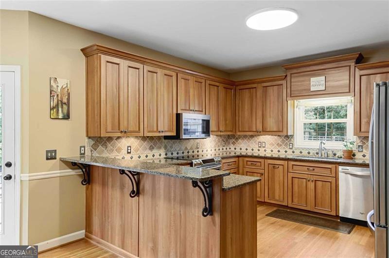 2203 Arbor Hill Road Canton, GA 30115 - Photo 38 of 64 a kitchen with a sink stove and cabinets