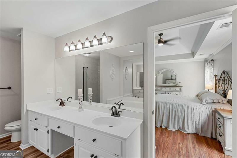 2203 Arbor Hill Road Canton, GA 30115 - Photo 44 of 64 a spacious bathroom with a double vanity sink and a mirror