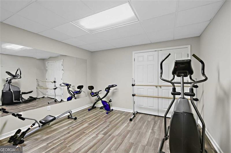 2203 Arbor Hill Road Canton, GA 30115 - Photo 52 of 64 a room with gym equipment and wooden floor