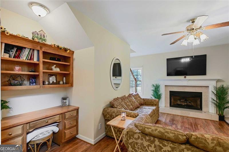 2203 Arbor Hill Road Canton, GA 30115 - Photo 56 of 64 a living room with furniture a flat screen tv and a fireplace