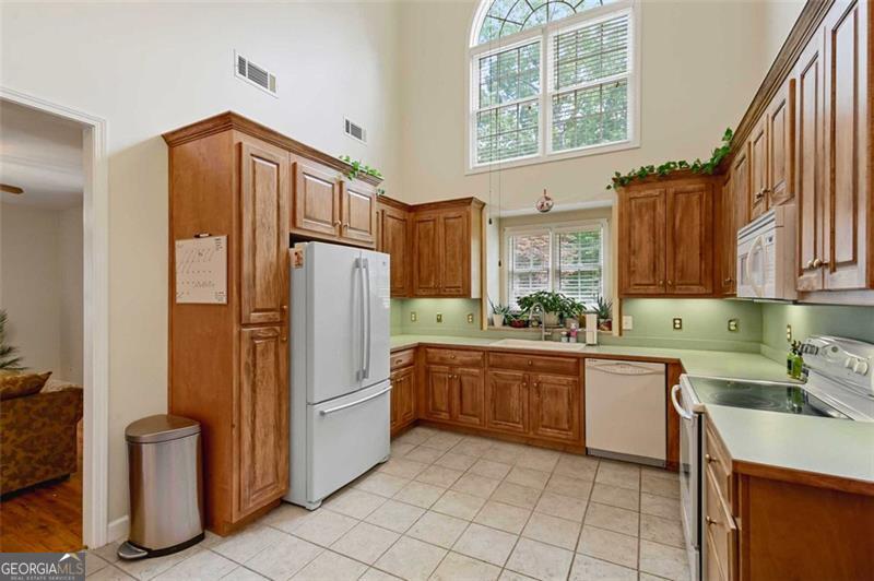 2203 Arbor Hill Road Canton, GA 30115 - Photo 57 of 64 a kitchen with stainless steel appliances granite countertop a refrigerator and a stove top oven