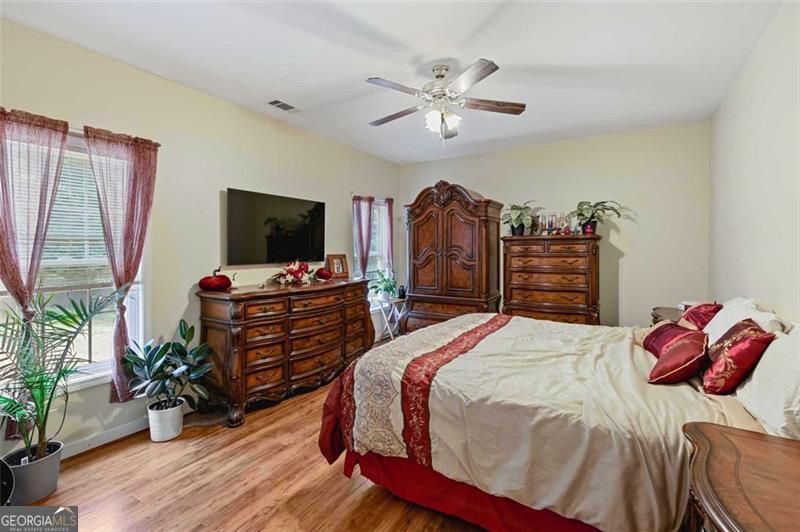 2203 Arbor Hill Road Canton, GA 30115 - Photo 59 of 64 a bedroom with a bed and a flat screen tv