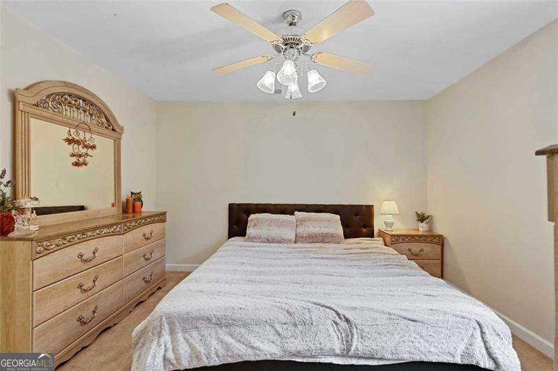 2203 Arbor Hill Road Canton, GA 30115 - Photo 62 of 64 a bedroom with a bed and a chandelier