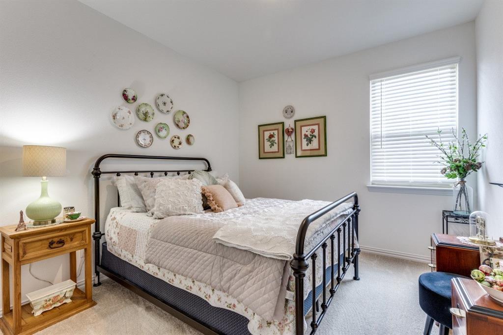 1213 Dragon Street Azle, TX 76020 - Photo 22 of 27 a bedroom with a bed and a chandelier