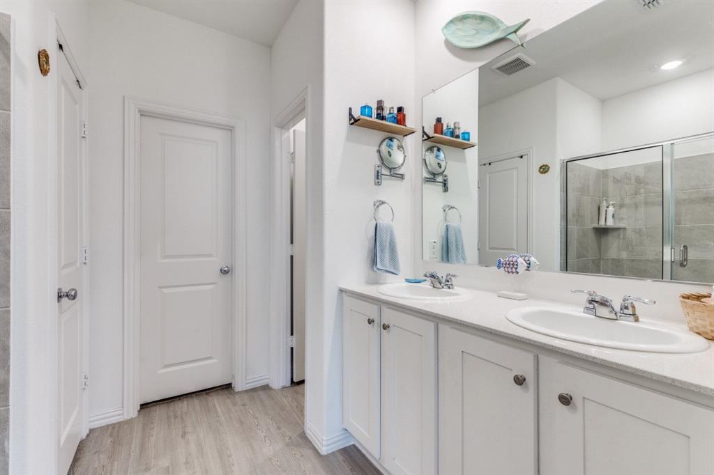 1213 Dragon Street Azle, TX 76020 - Photo 23 of 27 a bathroom with a double vanity sink mirror and shower