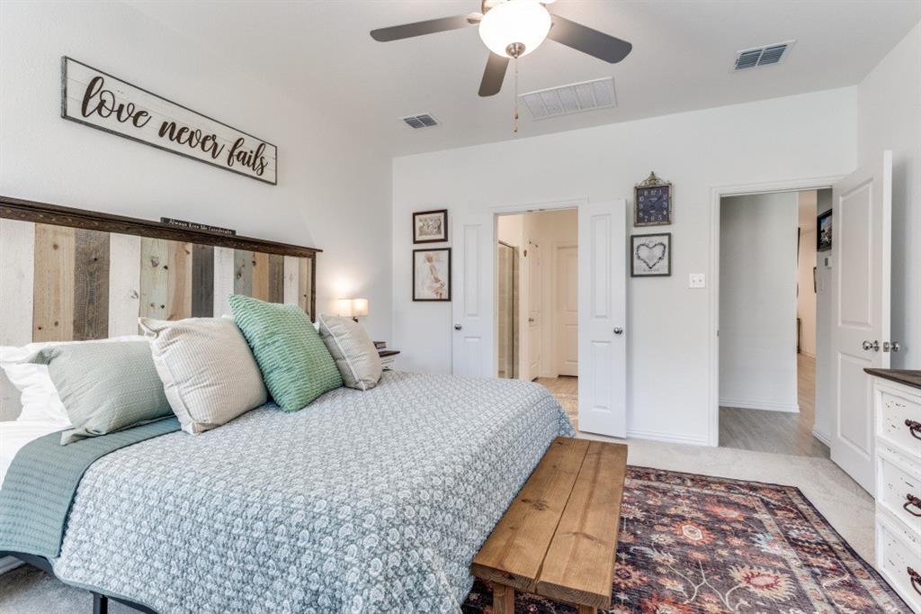 1213 Dragon Street Azle, TX 76020 - Photo 25 of 27 a bedroom with bed and a chandelier