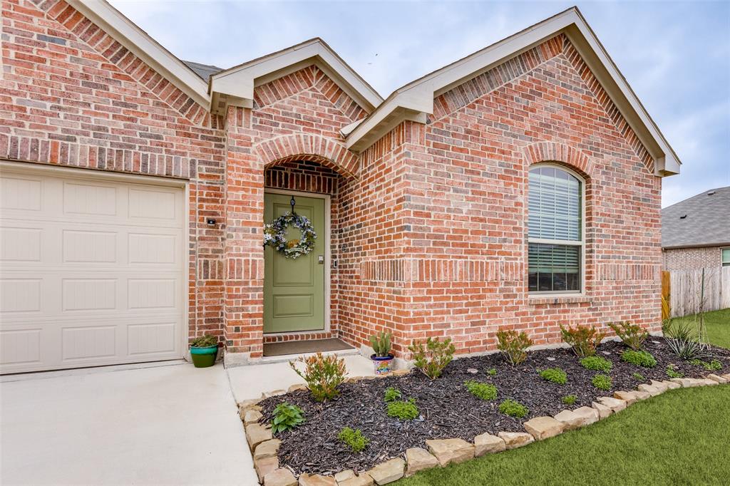 1213 Dragon Street Azle, TX 76020 - Photo 5 of 27 a front view of a house with a garden