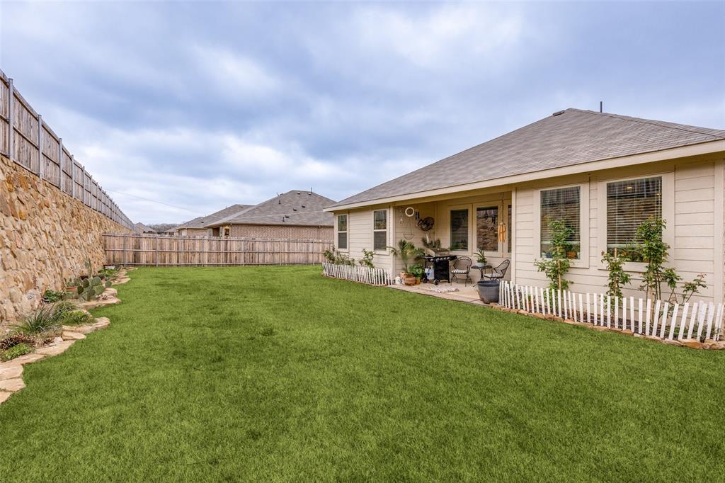 1213 Dragon Street Azle, TX 76020 - Photo 6 of 27 a view of a house with a back yard