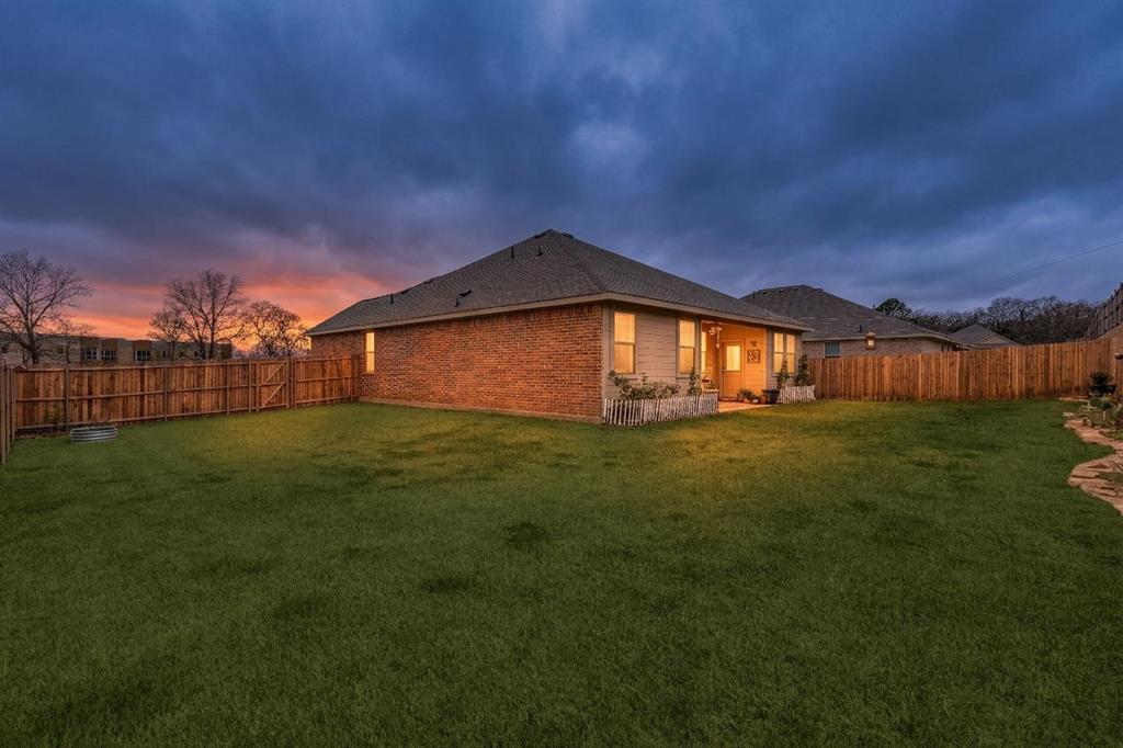 1213 Dragon Street Azle, TX 76020 - Photo 7 of 27 a backyard of a house with lots of green space