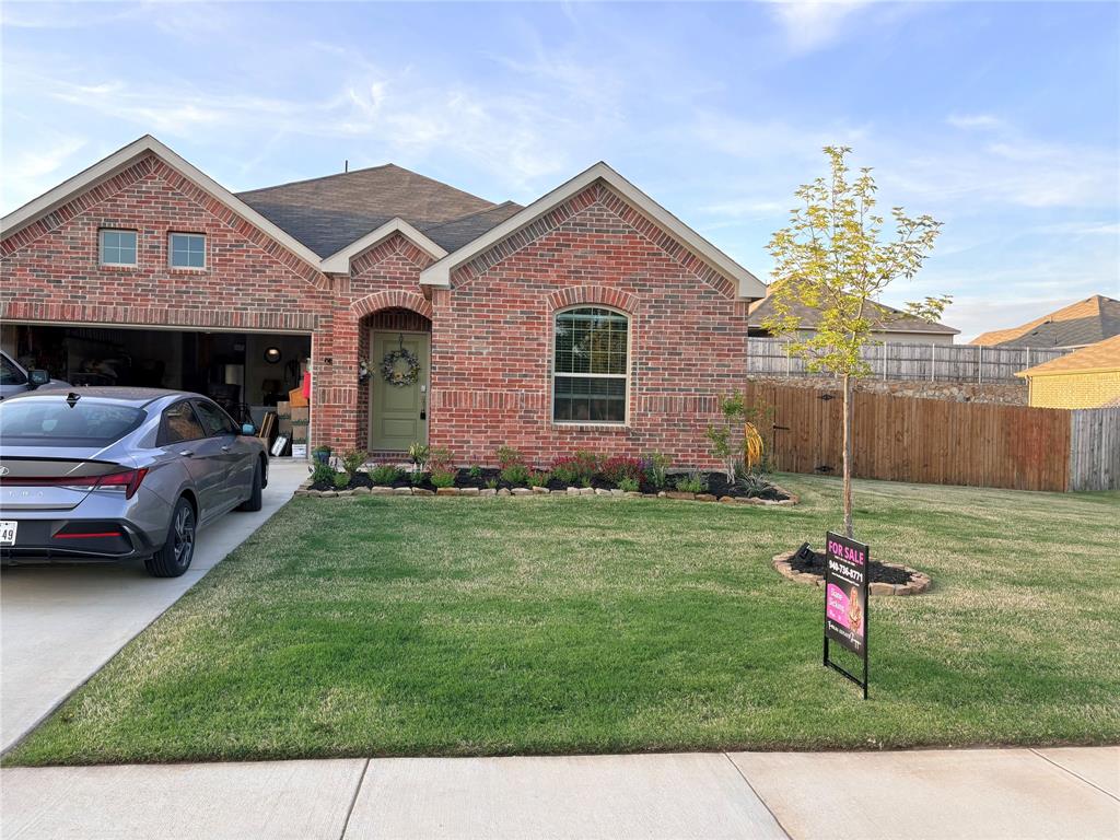 1213 Dragon Street Azle, TX 76020 - Photo 9 of 27 a front view of a house with a yard