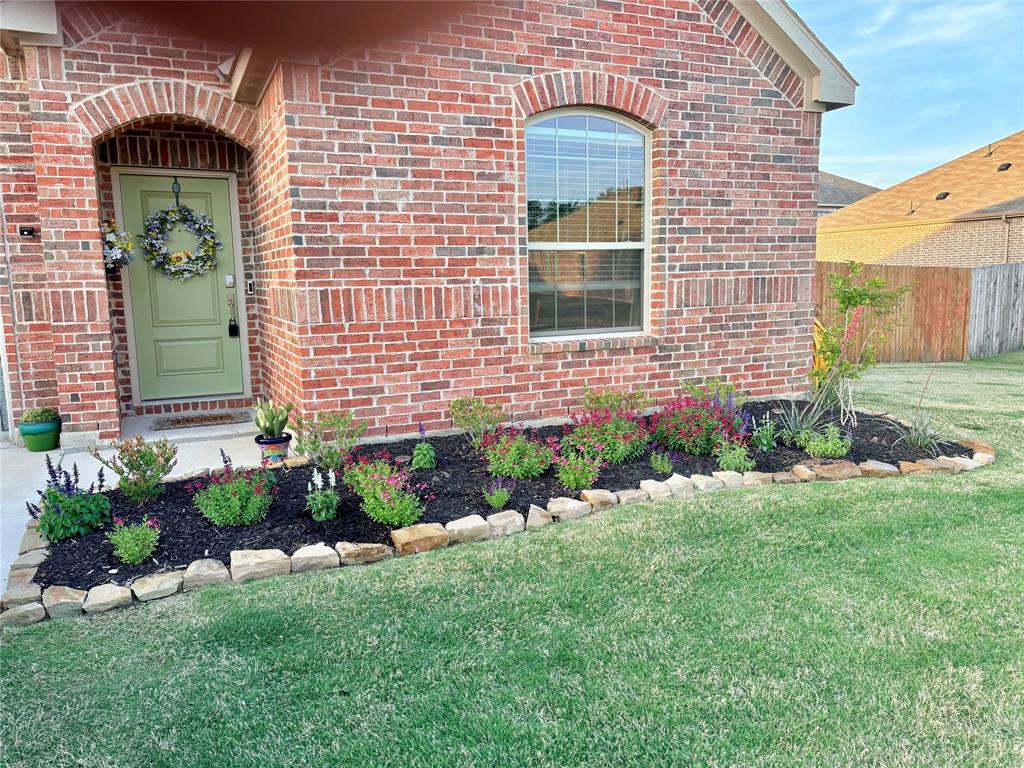 1213 Dragon Street Azle, TX 76020 - Photo 10 of 27 a front view of a house with a garden
