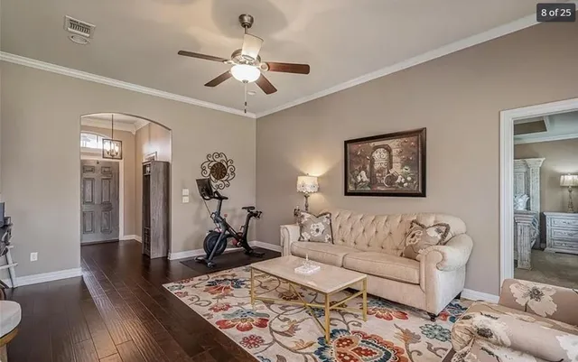 a living room with furniture and wooden floor