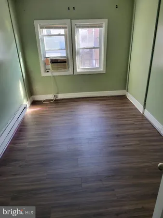 a view of room with window and wooden floor