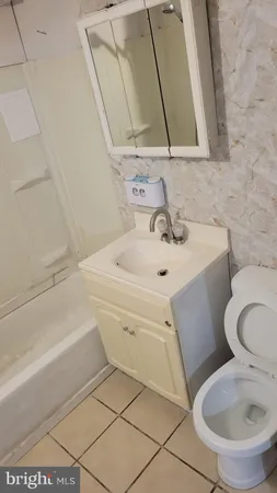 a bathroom with a sink a toilet and bathtub