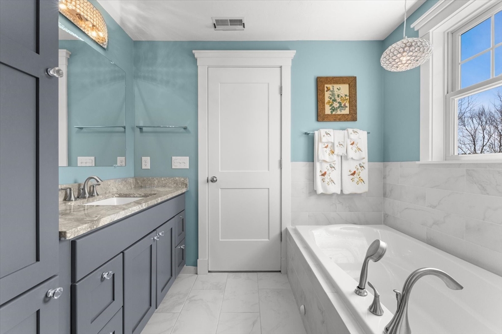 50 Quabbin Path Sutton, MA 01590 - Photo 26 of 42 a bathroom with a granite countertop tub sink and mirror